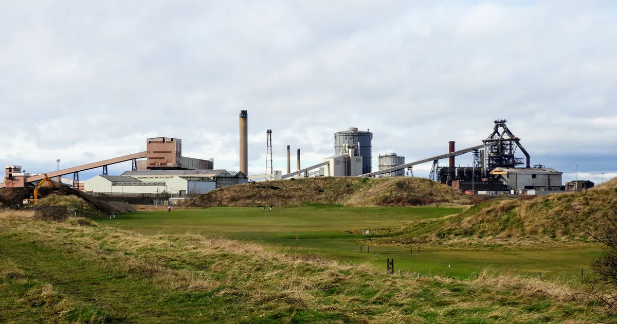 The former Redcar steelworks site on Teesside, now part of the Teesworks regeneration area, seen from across open ground.